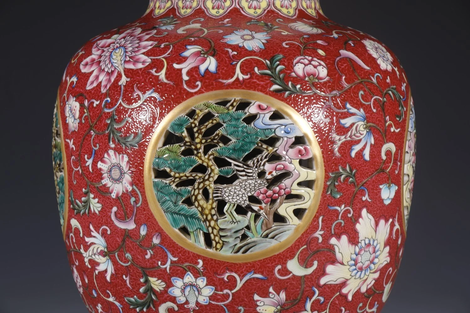 Close-up detail of the pine and crane painting framed by an openwork medallion
