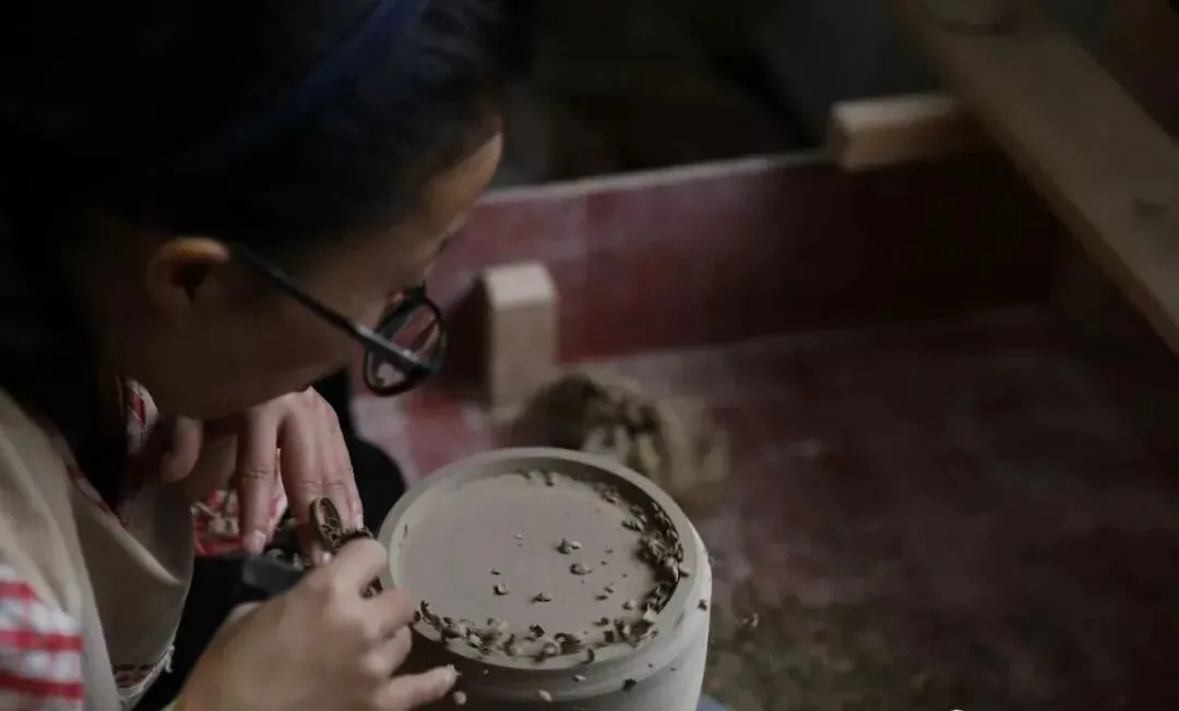 Artisan hand-painting a traditional Jingdezhen porcelain motif