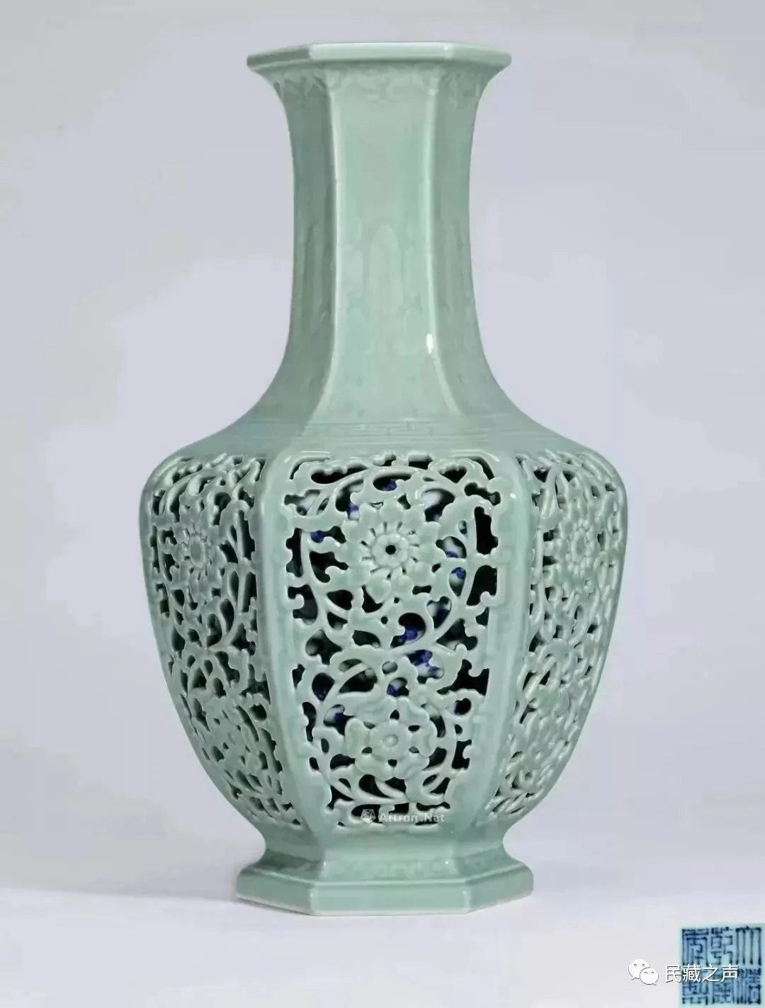 Full view of a pale green openwork porcelain vase with a long neck