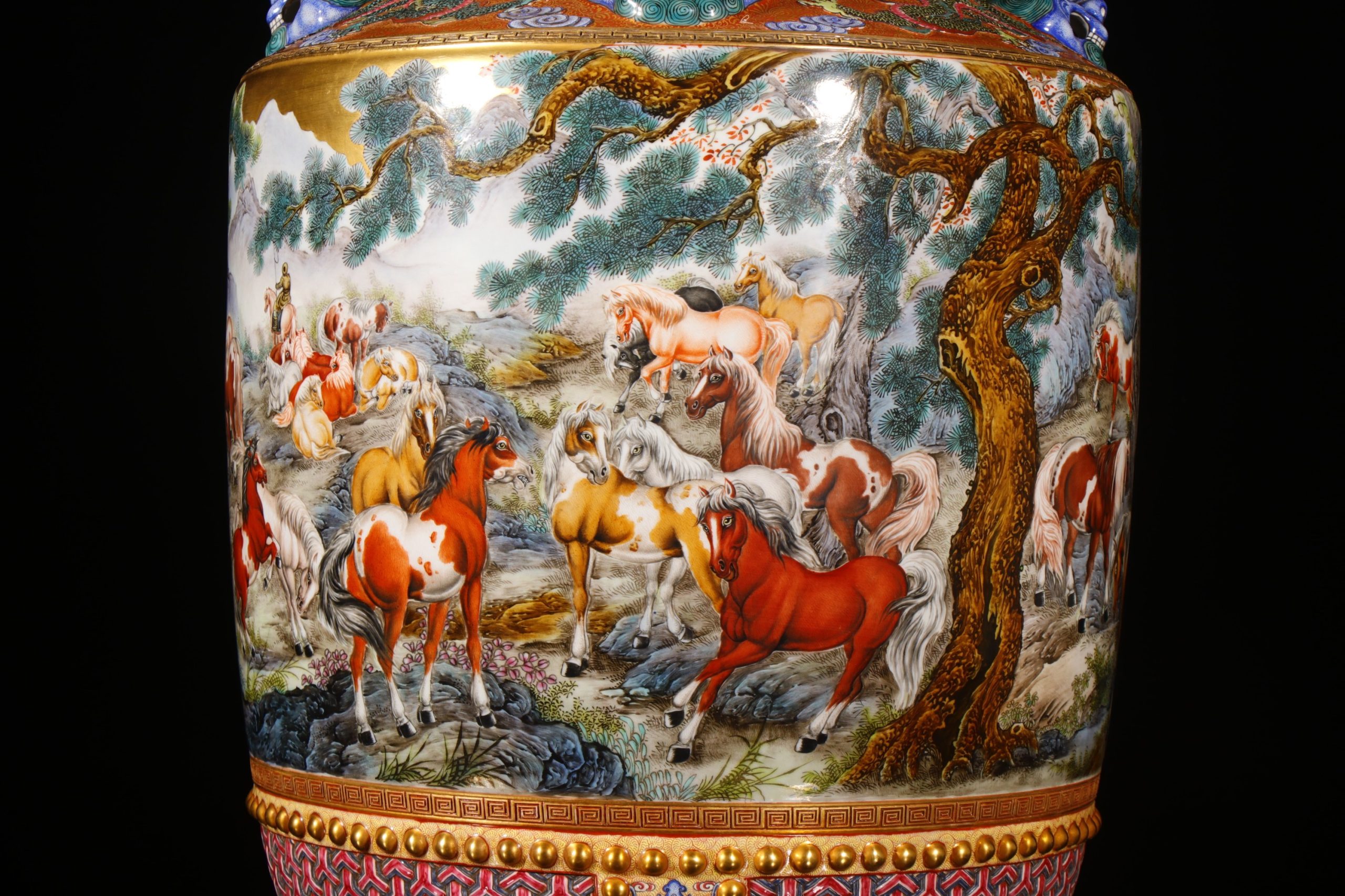 Close-up detail of the famille-rose Hundred Horses scene on the vase